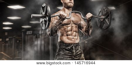Strong Athletic Man bodybuilderl Torso showing muscles in gym
