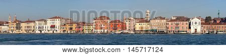 VENICE ITALY - DECEMBER 19: Panorama of Giudecca Canal Houses in Venice on DECEMBER 19 2012. Long Waterfront Cityscape in Venice Italy.