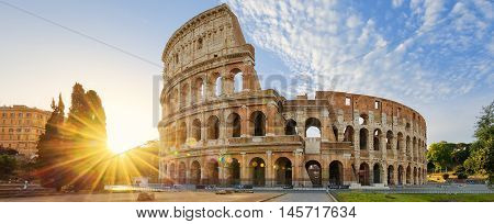 Panoramic view of Colosseum in Rome and morning sun Italy Europe.