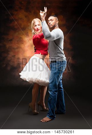 Young and sexy couple dances Caribbean Salsa