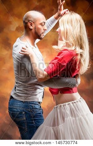 Young and sexy couple dances Caribbean Salsa