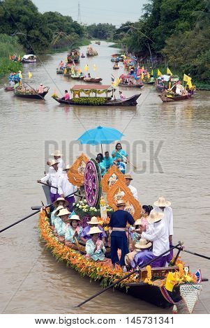 AYUTTHAYA, THAILAND - JULY 15, 2011: Unidentified people dancing show on the flower boats in candle floating parade, the unique annual candle festival of Buddhist lent  in Lad Chado, Ayutthaya, Thailand.
