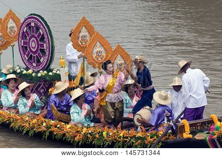 AYUTTHAYA, THAILAND - JULY 15, 2011: Unidentified people dancing show on the flower boats in candle floating parade, the unique annual candle festival of Buddhist lent  in Lad Chado, Ayutthaya, Thailand.
