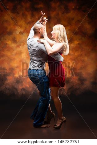 Young and sexy couple dances Caribbean Salsa