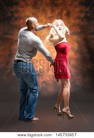 Young and sexy couple dances Caribbean Salsa