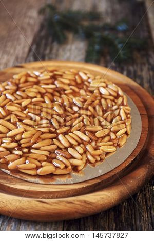 Spanish dessert: caramelized pine nuts and fir branches. Focus selective