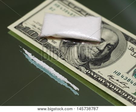 100 dollars money and drugs on the mirror