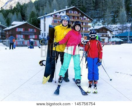 SWITZERLAND, SAAS-FEE, DECEMBER, 26, 2015 - Young active family enjoys winter sports in the charming Swiss resort of Saas-Fee, Switzerland