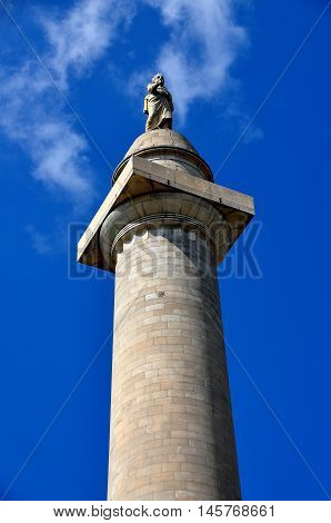 Baltimore Maryland - July 23 2013: Statue of George Washington dressed in a Roman toga tops the memorial column named in his honour at the center of Mount Vernon Place