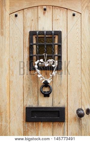 Traditional wooden front door of a house with ironmongery