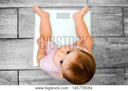 baby weight scale newborn grey floor background