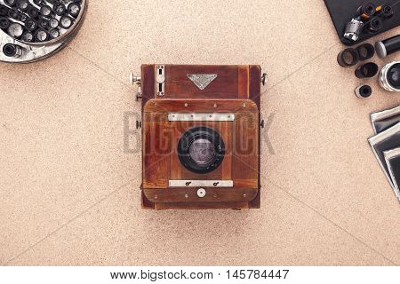 Many vintage cameras on wooden table. Photographer Desk. Photographer workplace. Tradional Photography. Black and White Photography. Negatives. Roll of films.