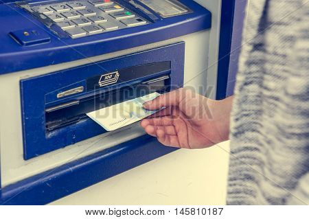 Closeup of receiving money from atm. Withdrawing funds.