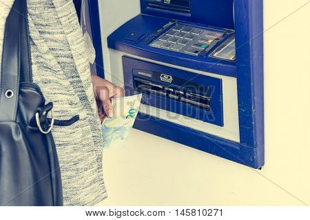 Closeup of receiving money from atm. Withdrawing funds.