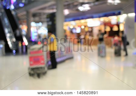 Abstract Background, Blurred Image Of A Man Working With Trolleys Luggage In Corridor Of Terminal Pa