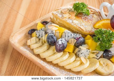 Pancake and fruit with ice cream on table