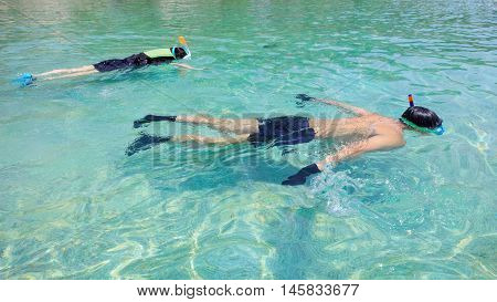 Snorkeling on an island beach with cristal clear water