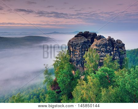 Sharp Sandstone Cliffs Above Deep Misty Valley. Popular Climbers Resor