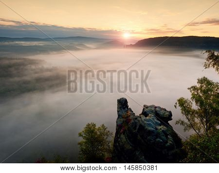 Sharp Sandstone Cliffs Above Deep Misty Valley. Popular Climbers Resor