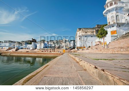 PUSHKAR, INDIA - FEB 9, 2015: Beautiful lake view near sacred Chandra and Varaha Ghats on Fabruary 9, 2015. With population of 15000 people Pushkar is a popular touristic town in Ajmer district