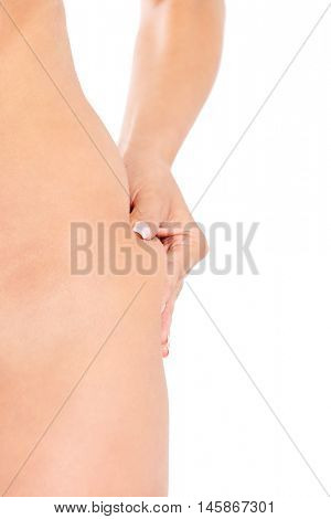 Slim woman pinch skin on hip