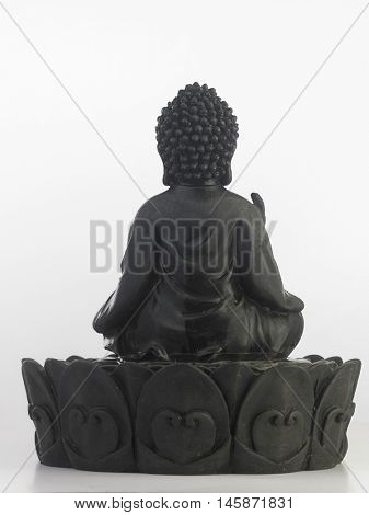 black Buddha statue in a sitting position on the white background