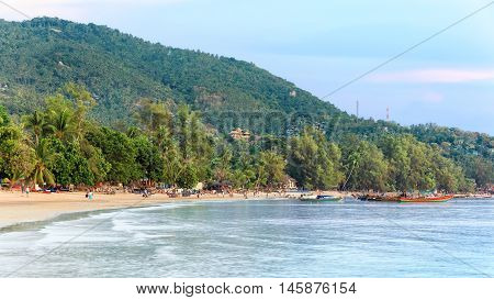 Sunset at Sairee beach with palmgrove during low tide