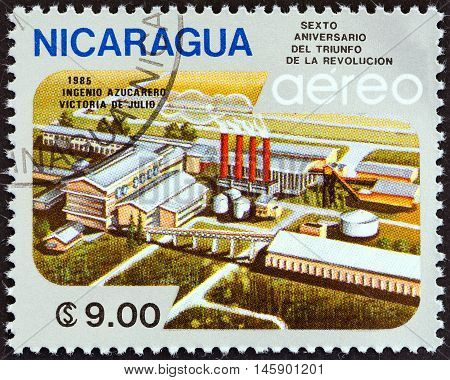 NICARAGUA - CIRCA 1985: A stamp printed in Nicaragua issued for the 6th anniversary of Revolution shows Victoria de Julio Sugar Factory, circa 1985.