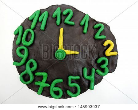 Round clock from plasticine going to winter time