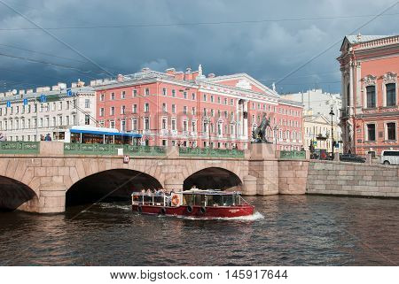 SAINT - PETERSBURG, RUSSIA - SEPTEMBER 5, 2016: People in the tourist boat sail on the Fontanka River under The Anichkov Bridge with The Horse Tamers by Peter Klodt near Nevsky Avenue