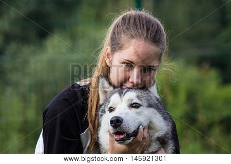 Beautiful girl with a beautiful dog breed Siberian Husky