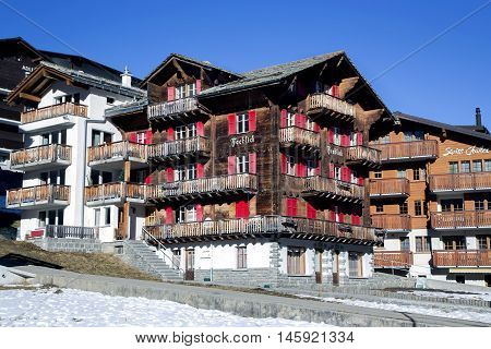 SWITZERLAND, SAAS-FEE, DECEMBER, 26, 2015 - Modern wooden hotels on a bright sunny day in the charming Swiss resort of Saas-Fee, Switzerland