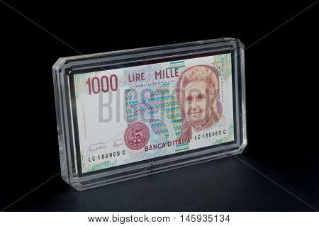 Old 1000 lire. Italian banknote on black background