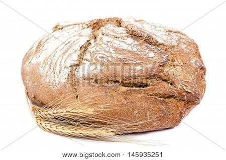 Fresh rye bread with wheat ears isolated on white background.