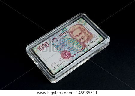 Old 1000 lire. Italian banknote on black background