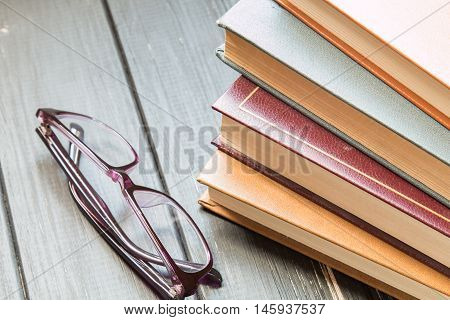 Several books on the dark wooden background