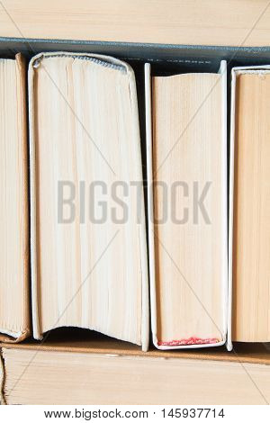 Spines of old books with many pages