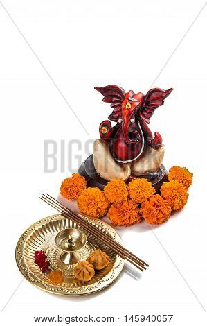 Hindu God Ganesha. Statue of Lord Ganesha. Pooja arrangement on white background.