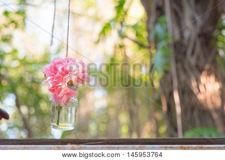 Pink Flower In Hanging Glass Bottle