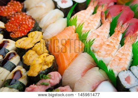 Japanese Sushi arranged on a traditional sushi tray.
