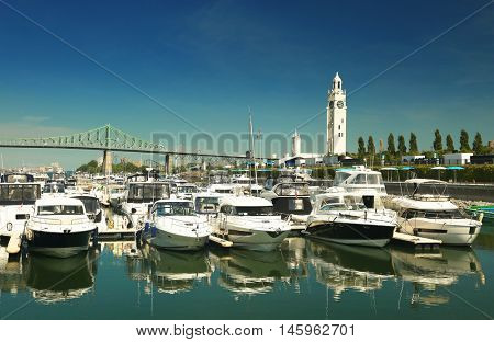 View of the marina with the clock tower in background in the old port of Montreal in Quebec city, Canada