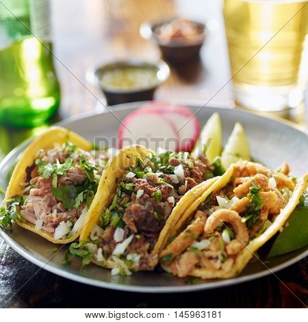 authentic mexican street tacos on plate with beef and pork