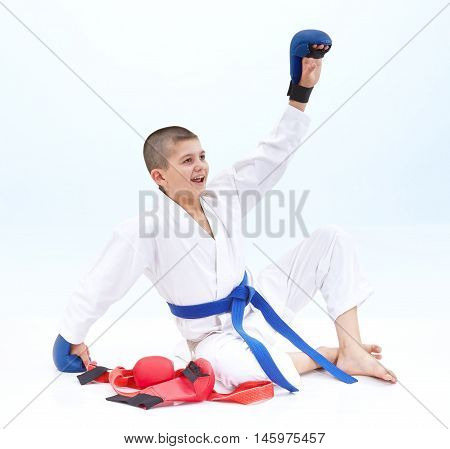 Boy athlete raised his left hand to greet