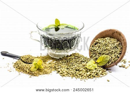 Raw Fennel With Its Powder And Its Beneficial Tea Or Extract In A Transparent Cup Isolated On White.