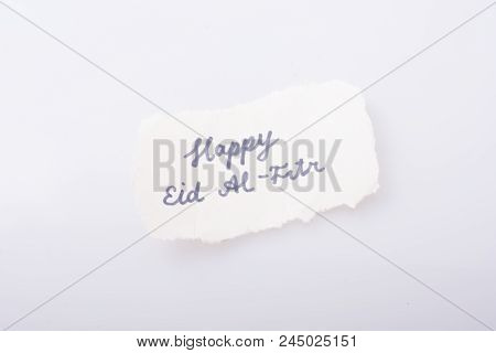 The Word Eid El Fitr  Written On A Piece Of Torn Paper