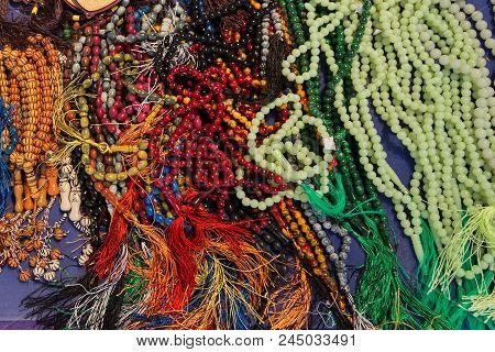 Multicolored Lot Of Tasbeeh Tasbih Beads. Huge Amount Of Muslim Prayer Beads Layeing On The Table. S