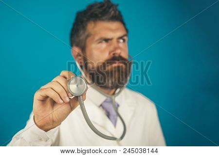 Doctor, Male Physician With Stethoscope In Hand, Focus On Stethoscope. Doctor Holds In Hand Stethosc
