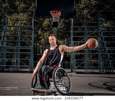 Portrait Of A Disabled Basketball Player In A Wheelchair On Open Gaming Ground.