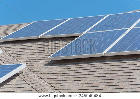 Solar Panel Installation On Asphalt Shingles Rooftop