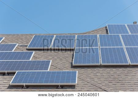 Solar Panel Installation On Asphalt Shingles Rooftop